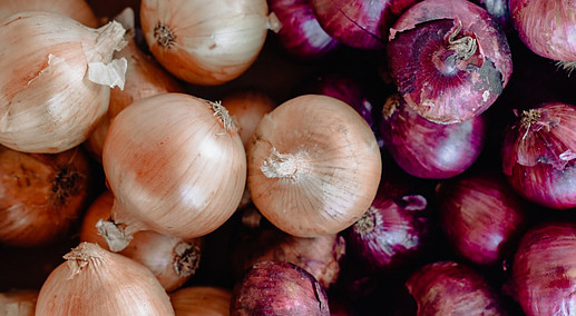 an assortment of red and white onions